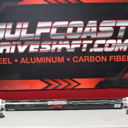 Carbon fiber driveshaft in black, featuring precision CNC machined aluminum flanges, displayed against a red and black backdrop with brand logos.